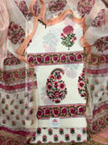Overhead flatlay of white cotton placement block print unstitched kurta – pink marigold butti top, large paisley floral centre panel with pink floral border, sheer Chanderi dupatta with pink floral border draped around
