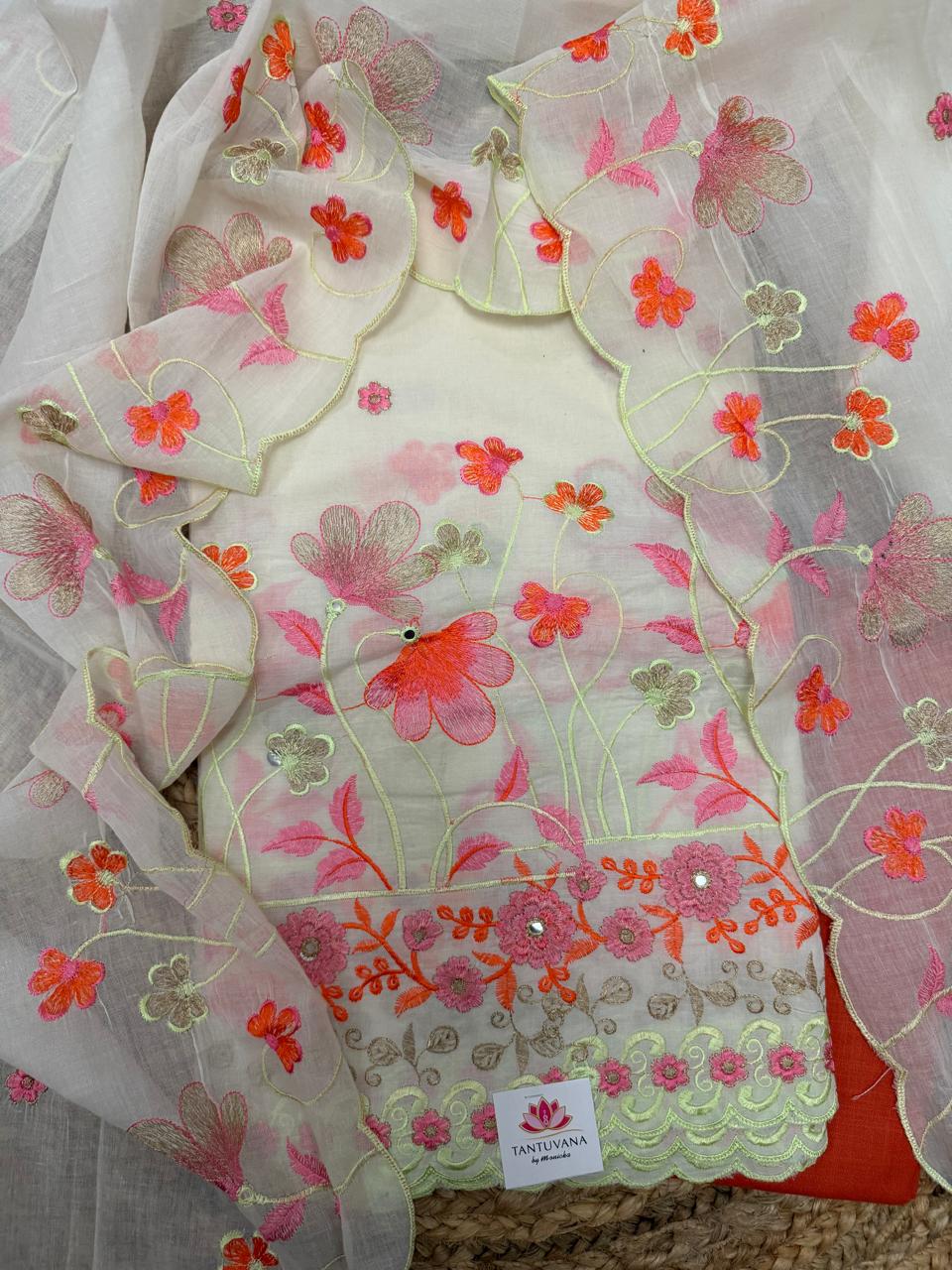 Cream Cotton 3-Piece Unstitched Suit Set Flat Lay – Orange & Pink Floral Garden Embroidery Kameez with Scallop Border & Orange Bottom