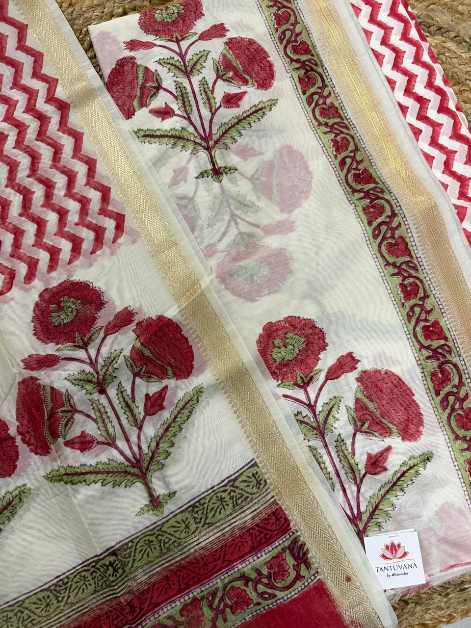 Straight flatlay of white cotton Mughal block print kurta and dupatta fabrics – red marigold floral body print with gold zari and green floral border, red chevron dupatta