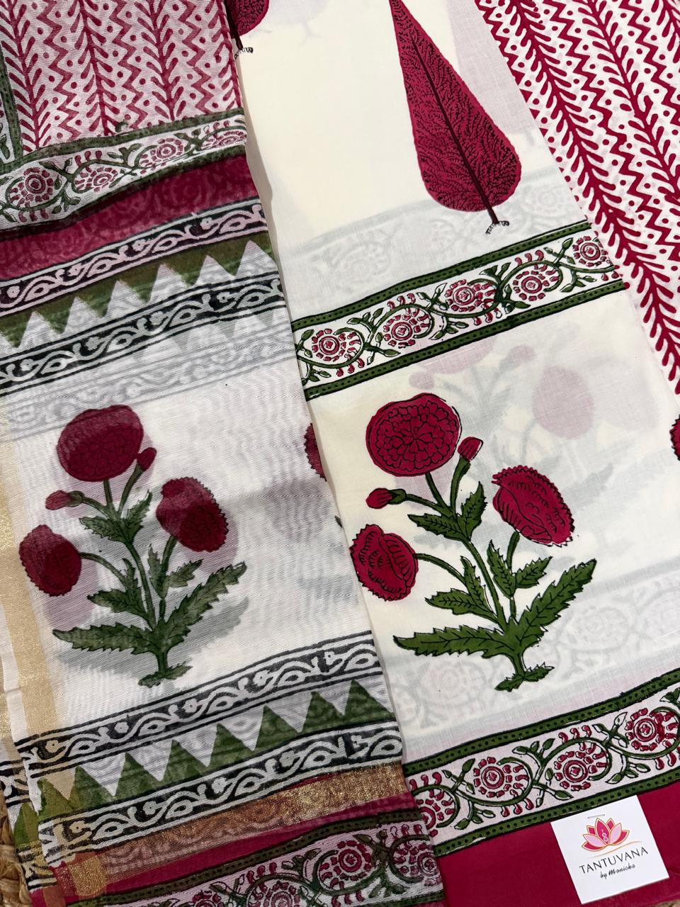 Angled flatlay of white cotton placement block print kurta – large red poppy flower with green leaves and green floral vine border strip, alongside Chanderi silk dupatta with red chevron body and red floral border with gold zari