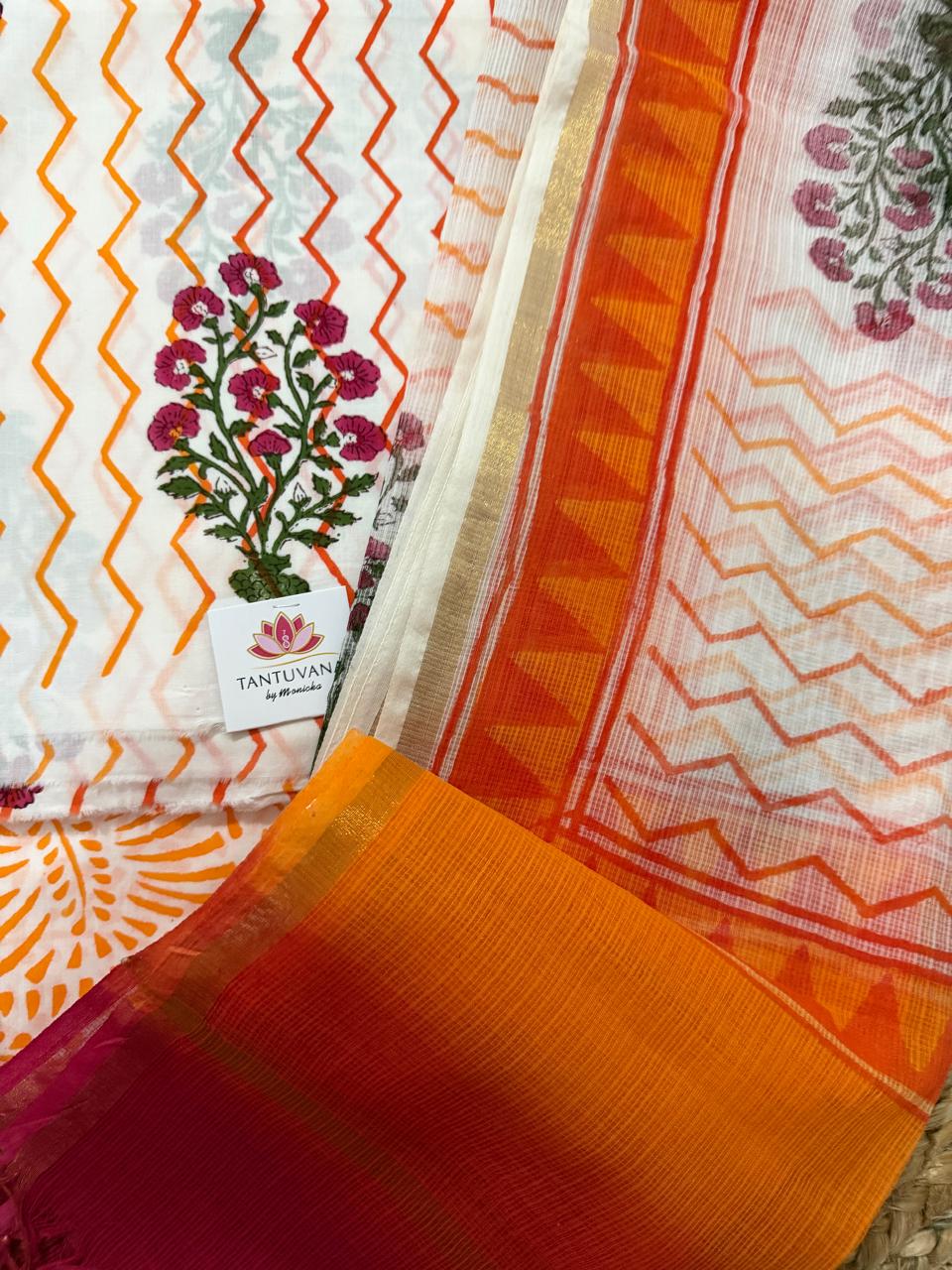 Close-up of white cotton Mughal block print kurta fabric – orange zigzag chevron with pink floral butti, alongside sheer Kota Doria dupatta with orange chevron print and solid orange border with gold zari