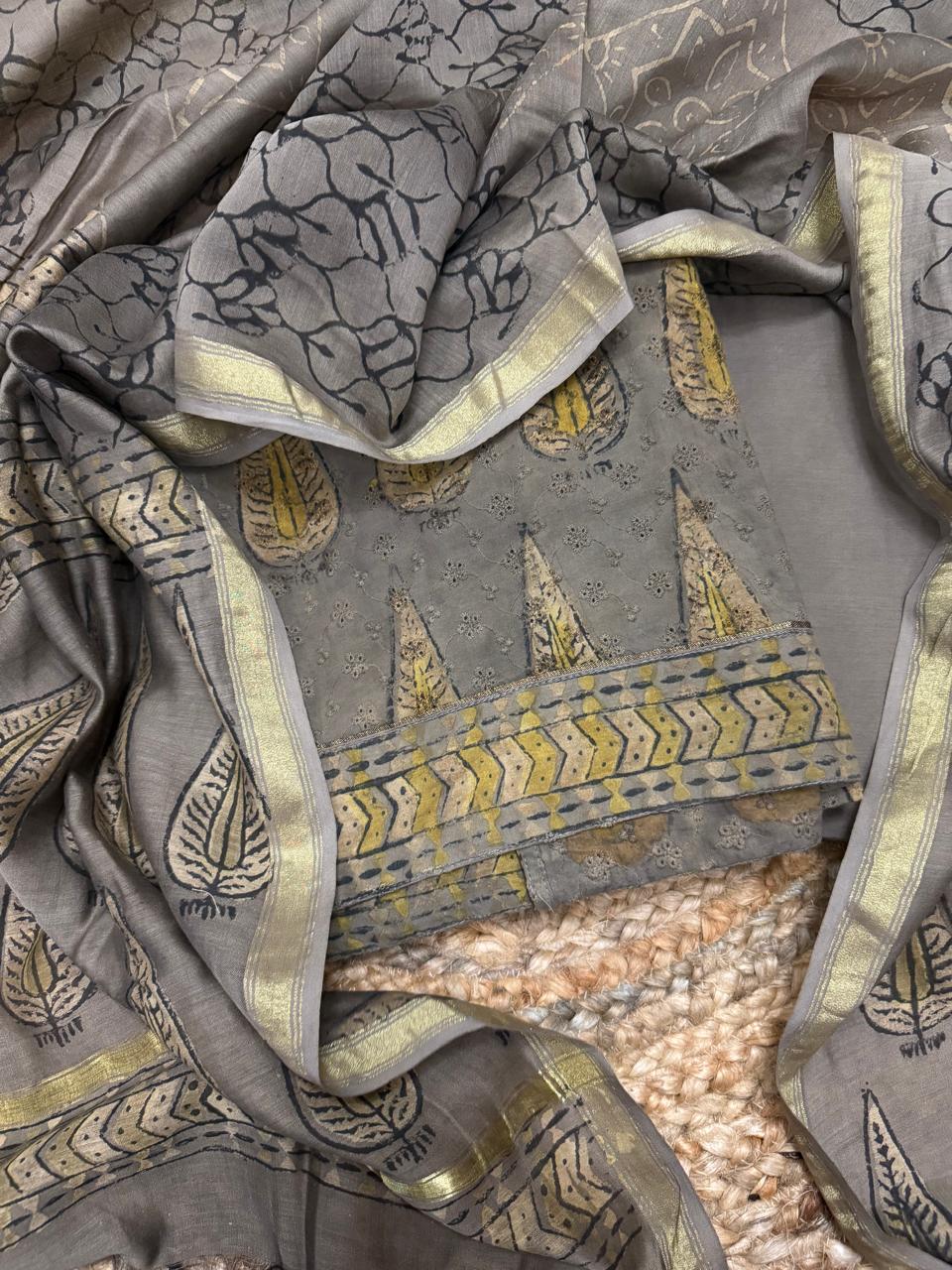  Ajrakh cotton hakoba kurta fabric flat lay showing Ajrakh block print border with gold chevron motifs and Chanderi silk dupatta with zari border
