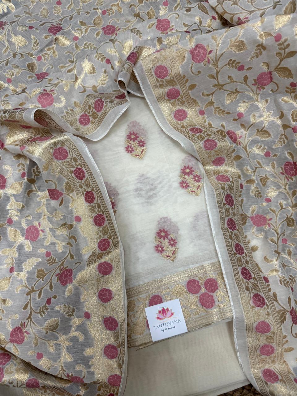 Cream & pink Banarasi woven Chanderi silk kurta fabric with floral butti motifs and gold zari border – flat lay detail