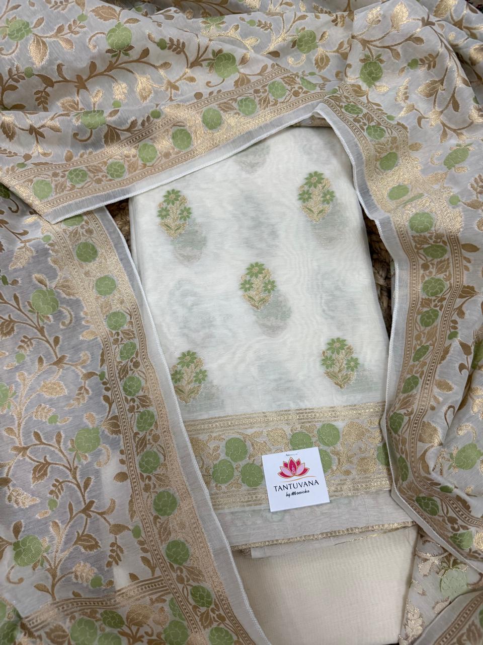 Cream & green Banarasi woven Chanderi silk 3-piece unstitched suit set – overhead flat lay with kurta fabric, green floral butti, and woven dupatta