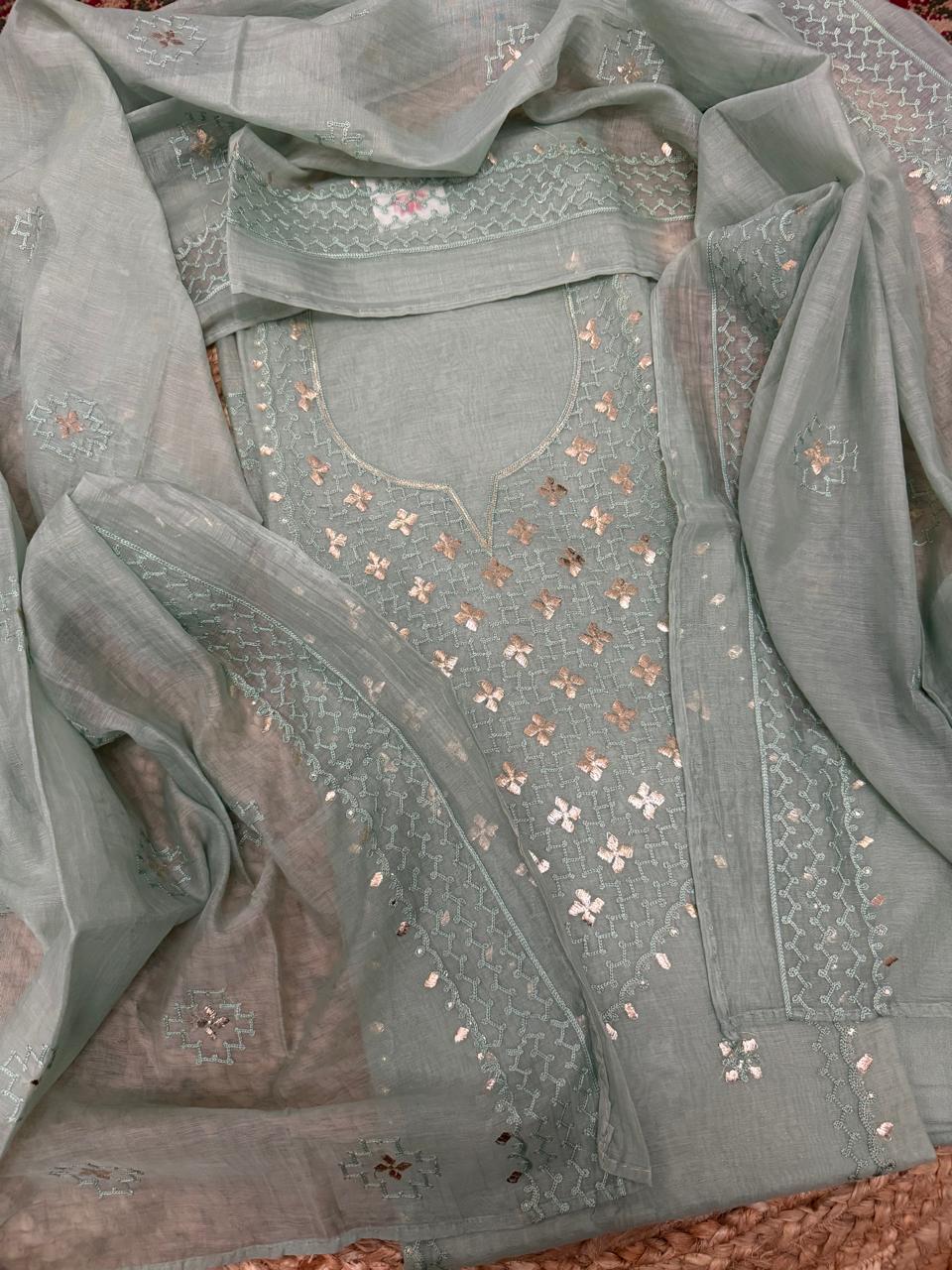 Powder green Chanderi silk unstitched kurta – overhead flat lay with round neckline, all-over pita work floral butti, silver sequin detailing, and dupatta