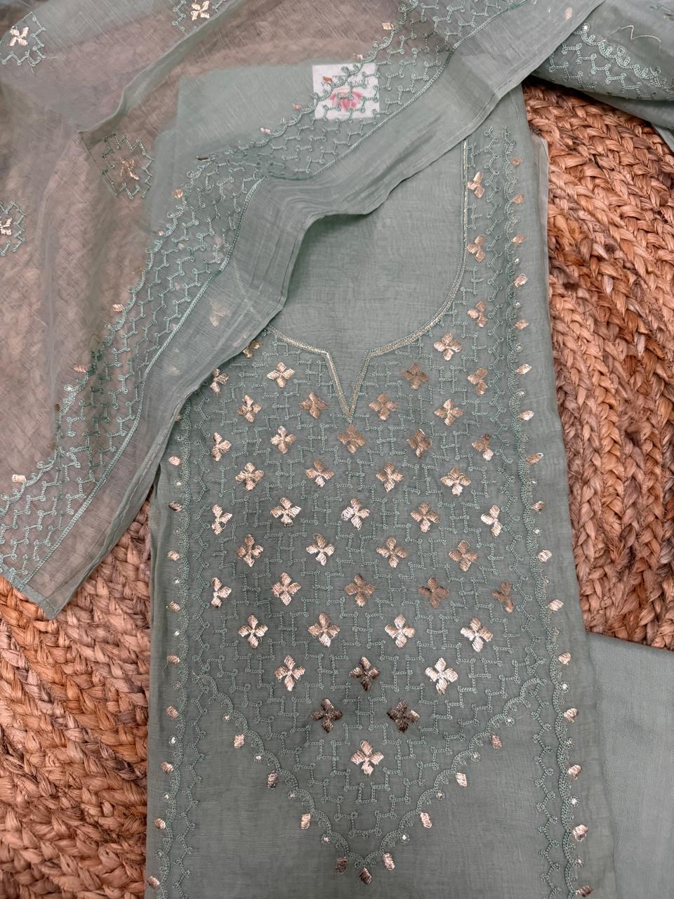Powder green Chanderi silk kurta fabric – flat lay on rattan surface showing V-neckline with all-over pita work gold floral butti and silver sequin jaal embroidery