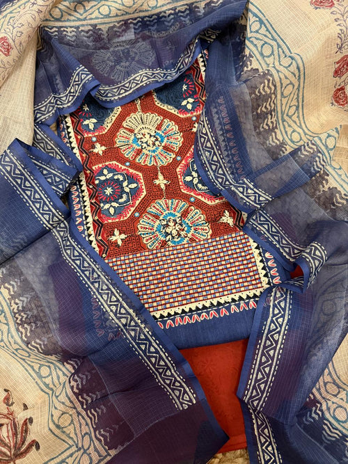 Navy blue and rust 3-piece unstitched suit set – overhead flat lay showing patched neckline with rust Ajrakh hexagonal block print panel, navy blue kurta, and Kota Doria dupatta with geometric border