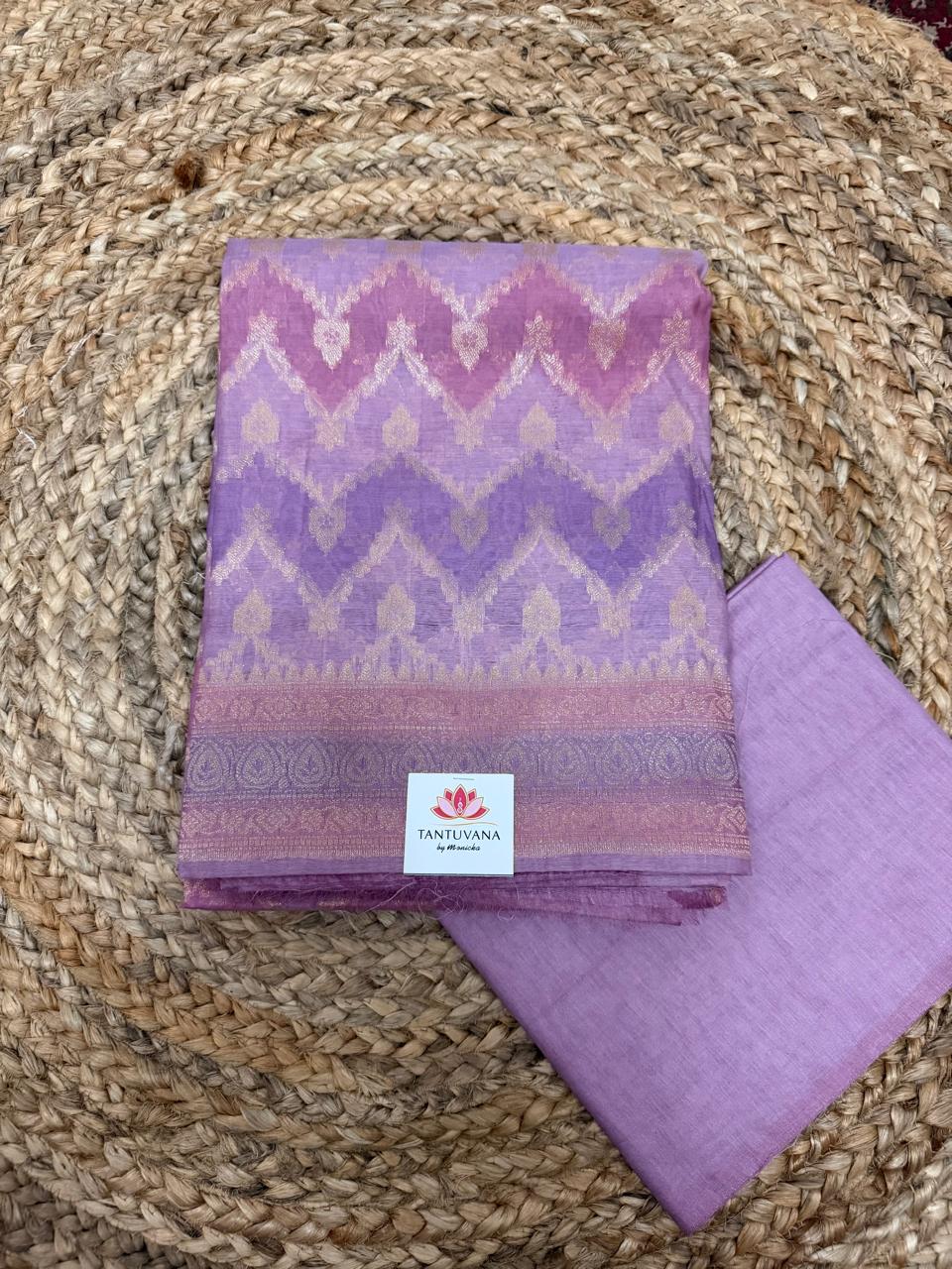 Purple Banarasi Chanderi silk kurta – close-up flat lay on rattan showing pink, mauve, and lavender multi-shade chevron Banarasi weave with silver-gold zari lotus motifs, scrolling zari paisley border, plain lavender cotton bottom