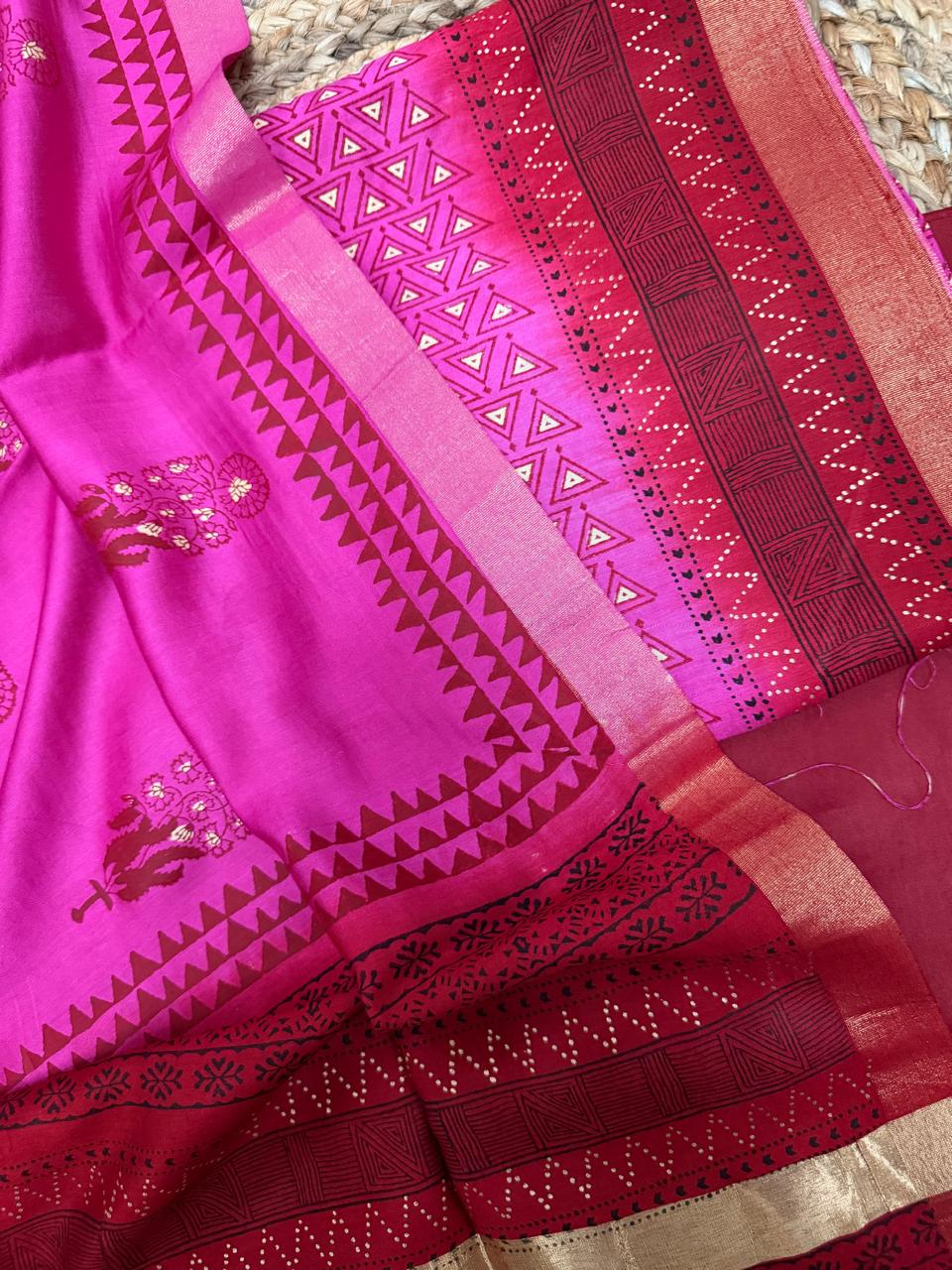 Pink Maheshwari silk kurta – angled close-up of dense white triangle geometric khari print with red border, red maze block print and bandhani dot band, fuchsia silk dupatta with floral butti motifs and gold zari border