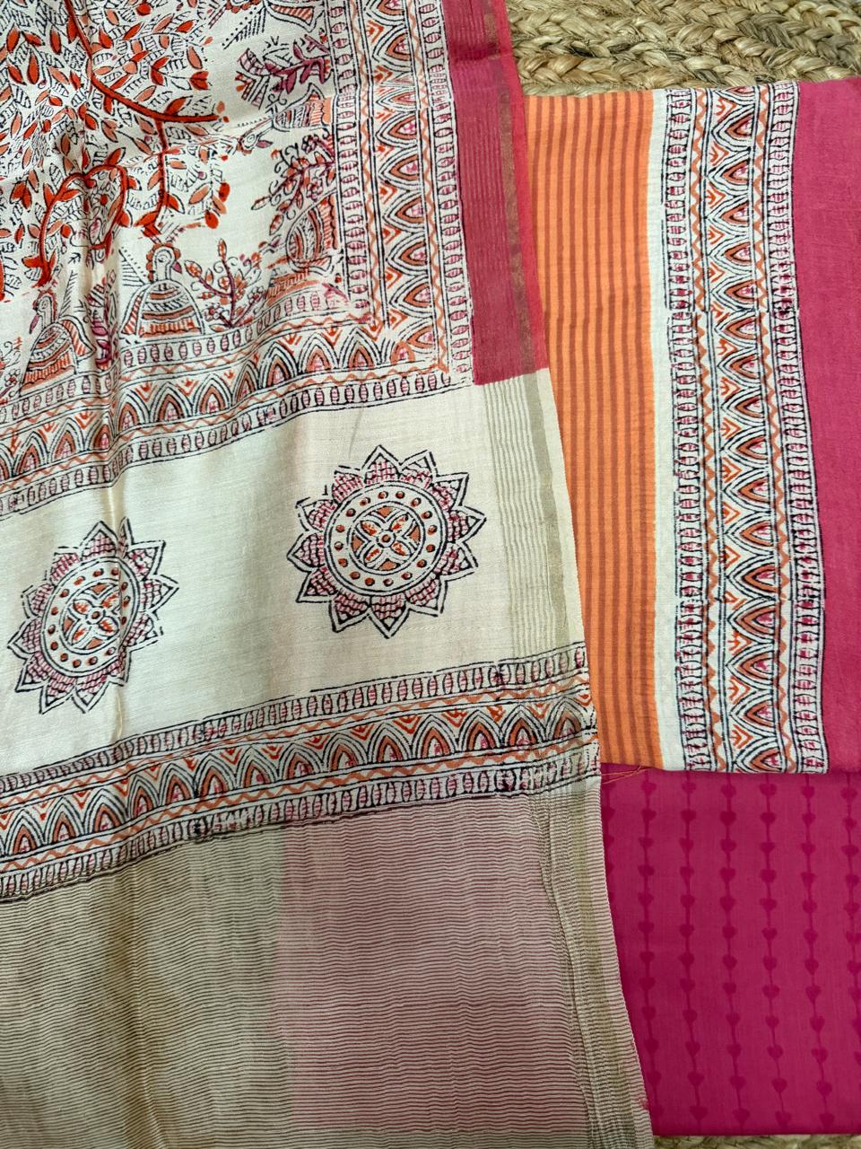 Cream Madhubani block print dupatta – close-up flat lay showing black sun mandala butti, red floral vine all-over print, multicolour temple arch border with peacock motifs, alongside orange stripe Maheshwari kurta and fuchsia diamond block printed bottom