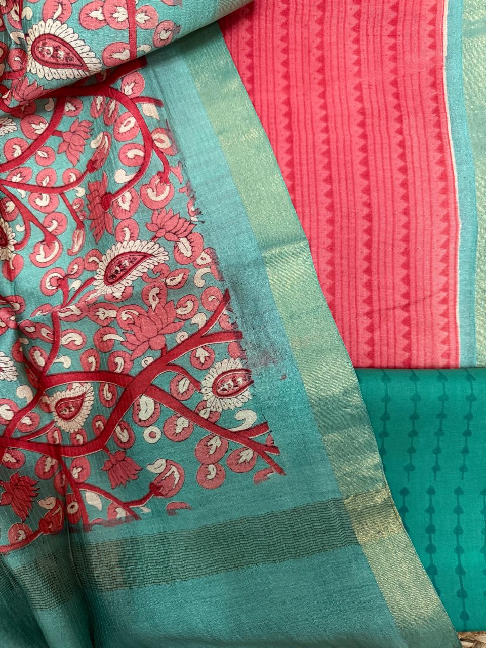 Teal Kalamkari Maheshwari silk dupatta – close-up showing pink lotus and paisley all-over print with dark red floral vine, gold zari border, alongside coral stripe zigzag Maheshwari kurta and teal dot-stripe cotton bottom